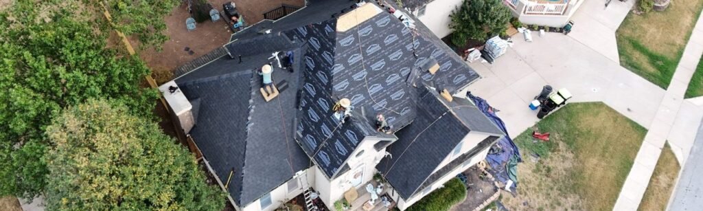 Bold Roofing crew replacing a steep roof on a Springfield, MO home, drone view